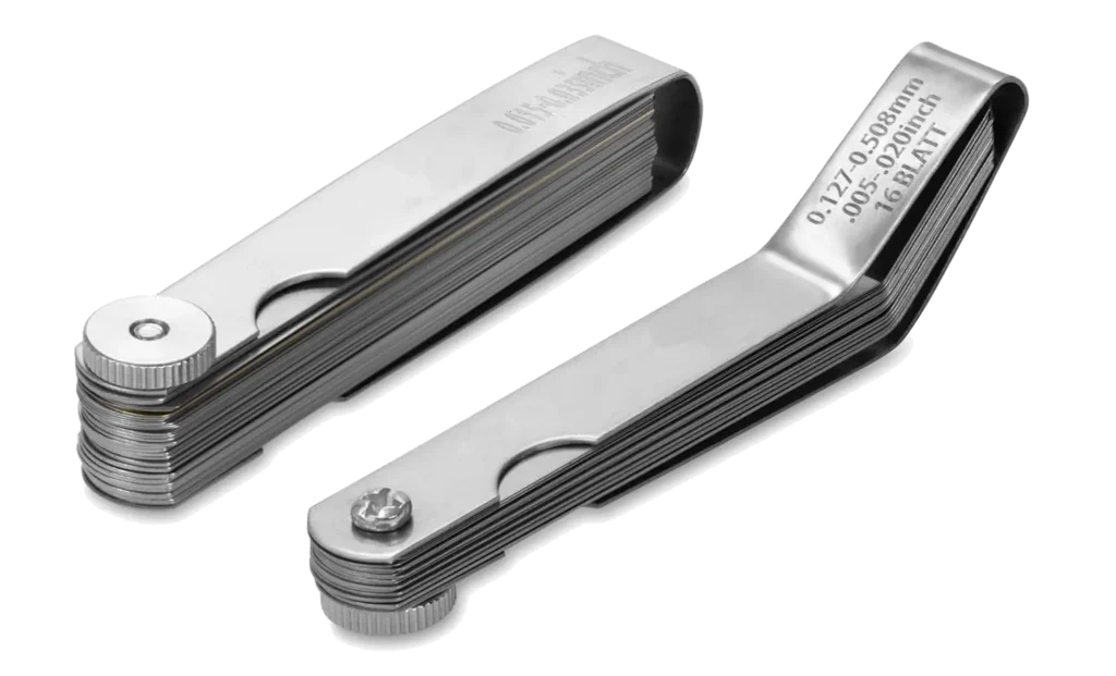 Mutt Tools 2-Piece Feeler Gauge Set showing the straight and angled gauges closed, with laser-etched metric and inch measurements visible.